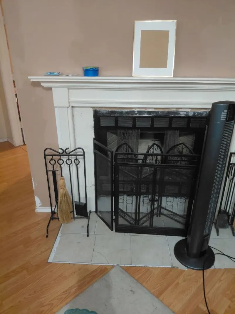 Black wrought iron fireplace screen, tool set with broom and tower fan