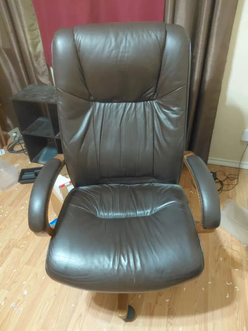 Brown leather high-back executive office chair with wood armrests
