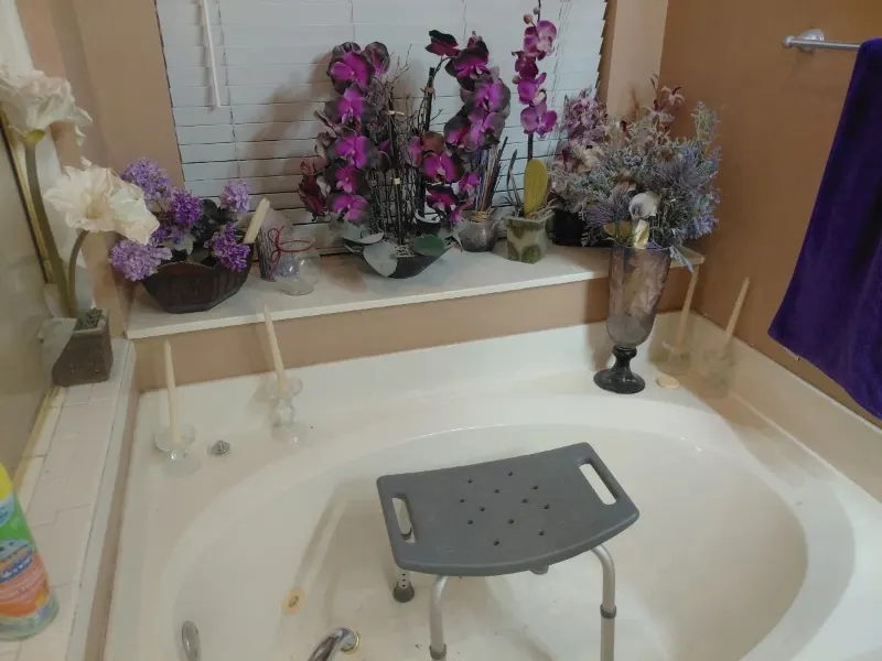 Artificial purple orchid arrangements, faux floral decor and shower chair